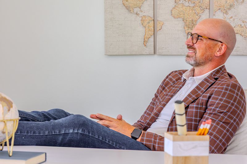 Alex McConeghey relaxing in a staged home office